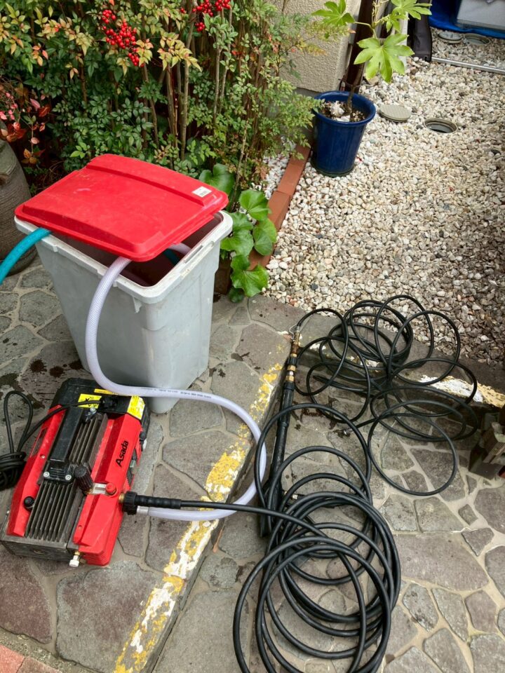 Asada製業務用高圧洗浄機と大量の洗浄ホース。屋外に設置して作業準備